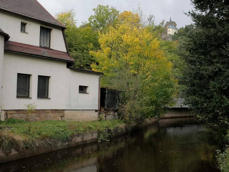 Residential home beside a calm waterway where elevation information helps buyers understand site conditions.