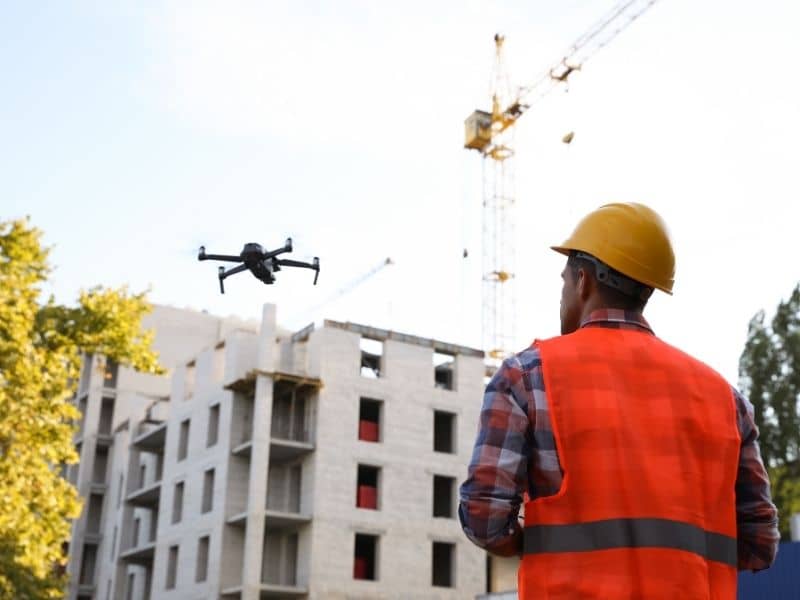 Drone flying over a construction site to support Drone LiDAR Mapping for terrain review and buildable area planning.